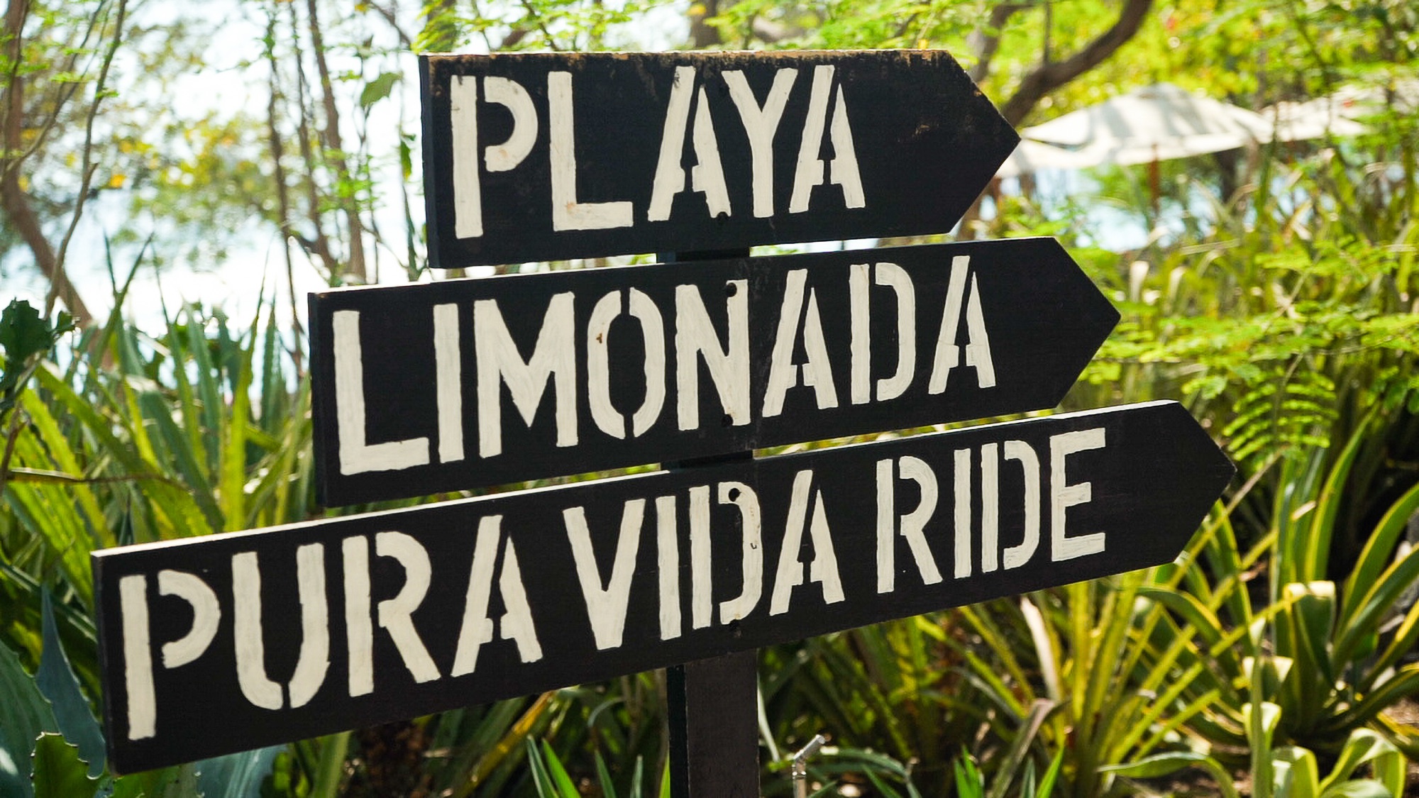 Playa, Limonada, and Pura Vida Ride signpost, Las Catalinas, Costa Rica