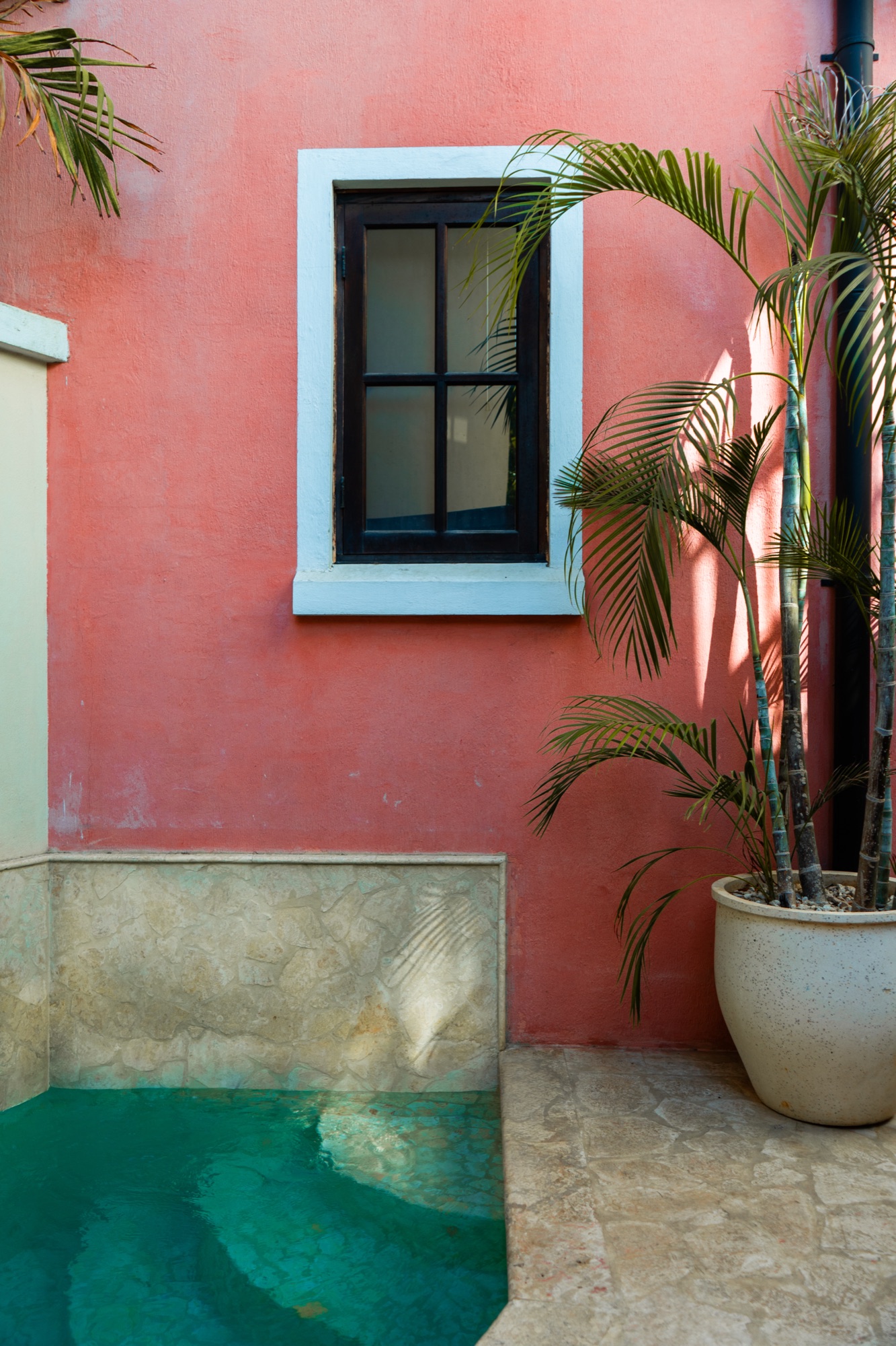 Pink building facade with plunge pool, Las Catalinas, Costa Rica