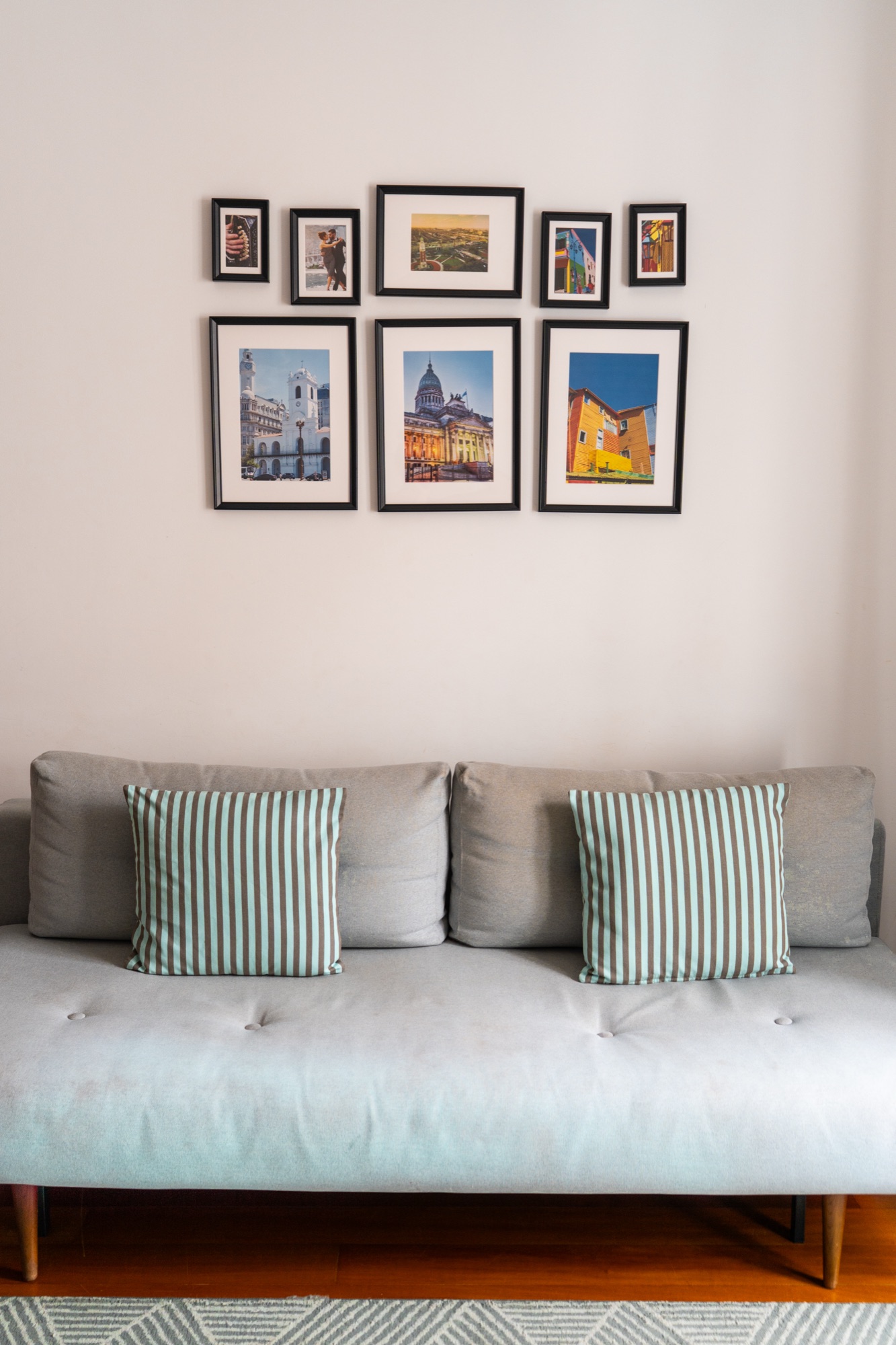 Living room seating area beneath a photo gallery wall, Madeira, Portugal