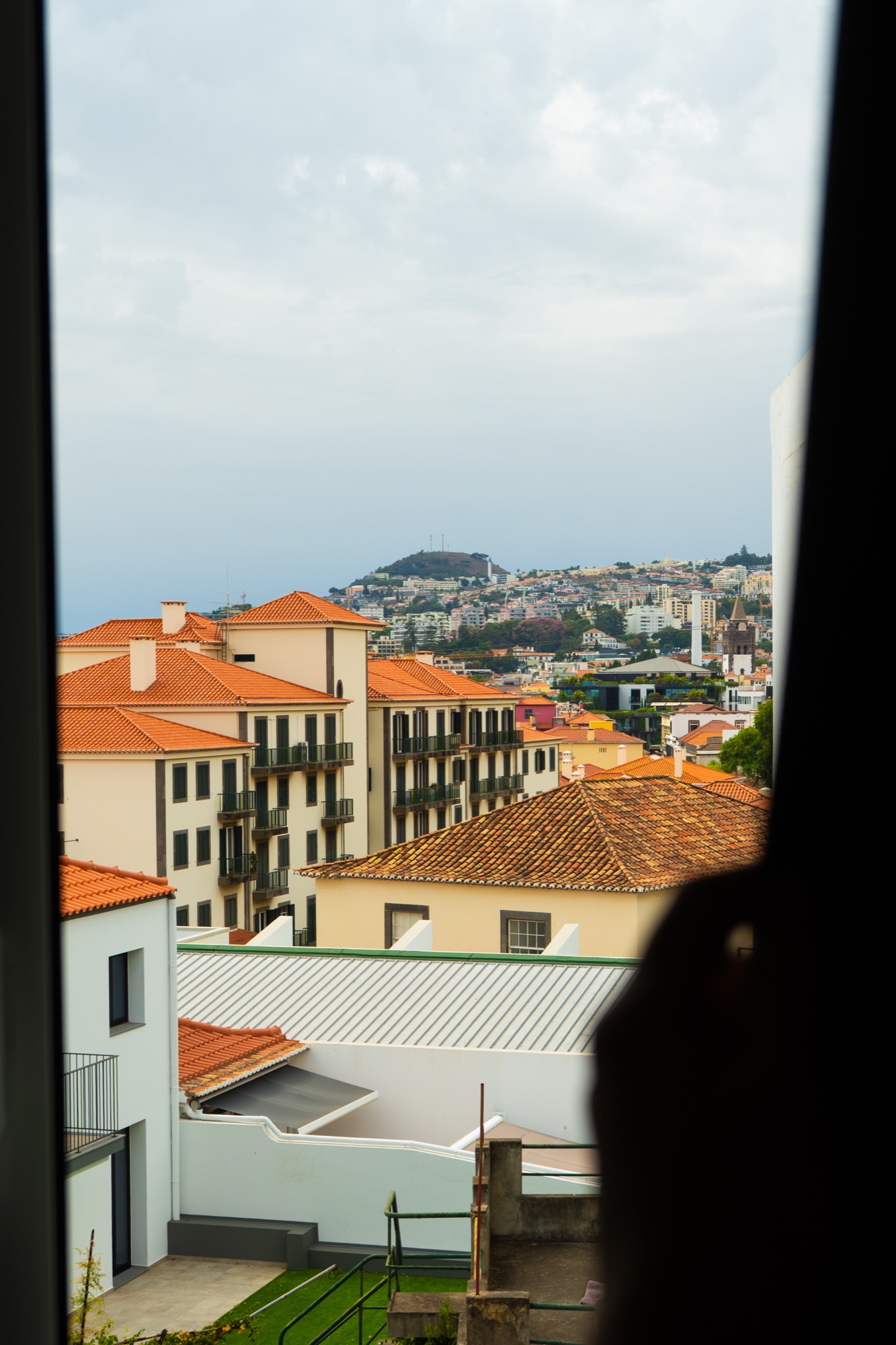 View of terracotta rooftops from a window, Madeira, Portugal