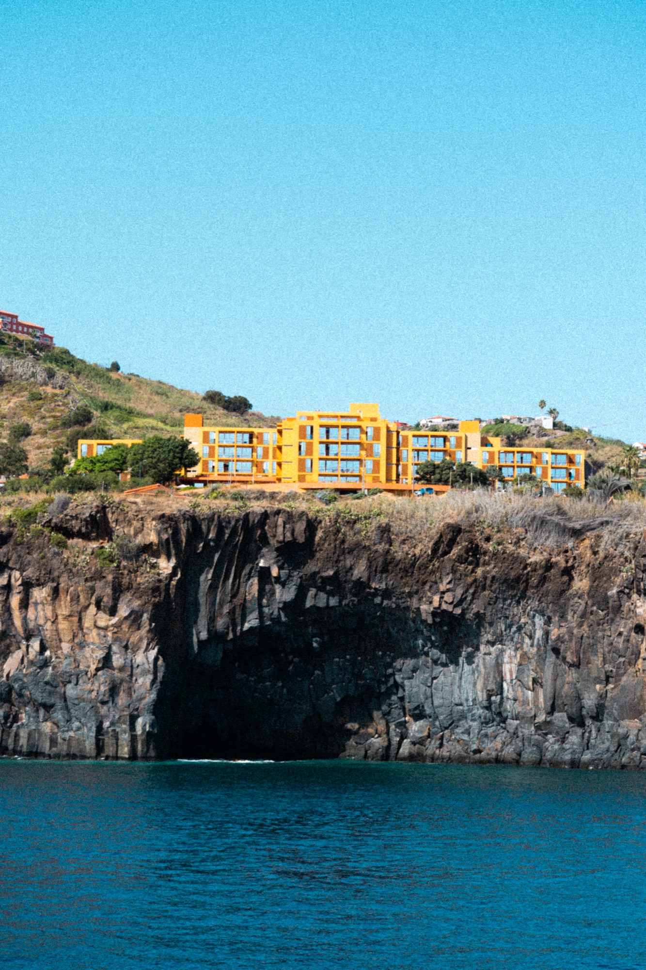 Yellow cliffside hotel overlooking the Atlantic, Madeira, Portugal