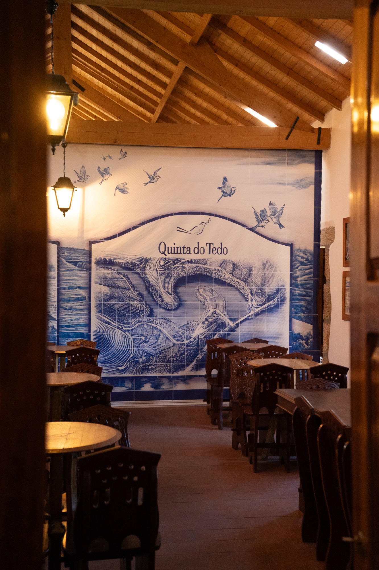 Dining room with a hand-painted azulejo tile mural of the Quinta do Tedo estate, Douro Valley, Portugal