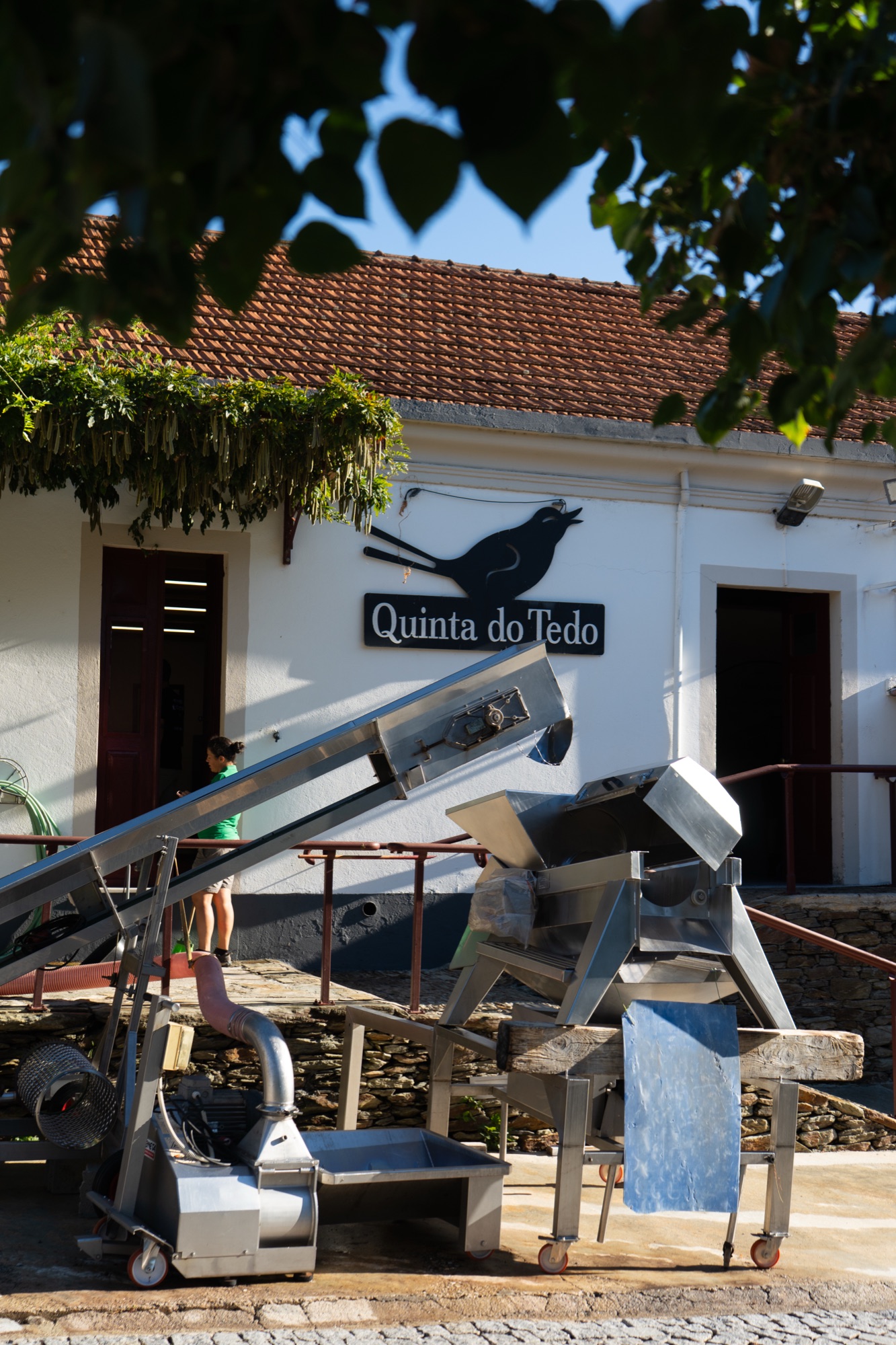 Exterior of the Quinta do Tedo winery with harvesting equipment, Douro Valley, Portugal