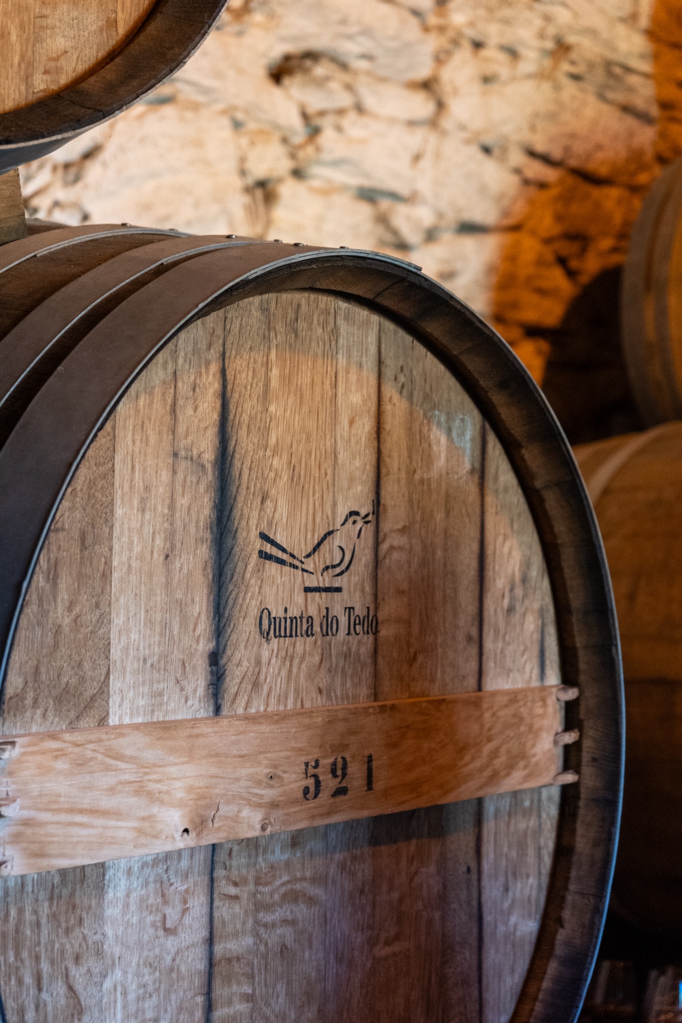 Close-up of an oak barrel branded with the Quinta do Tedo bird logo, Douro Valley, Portugal